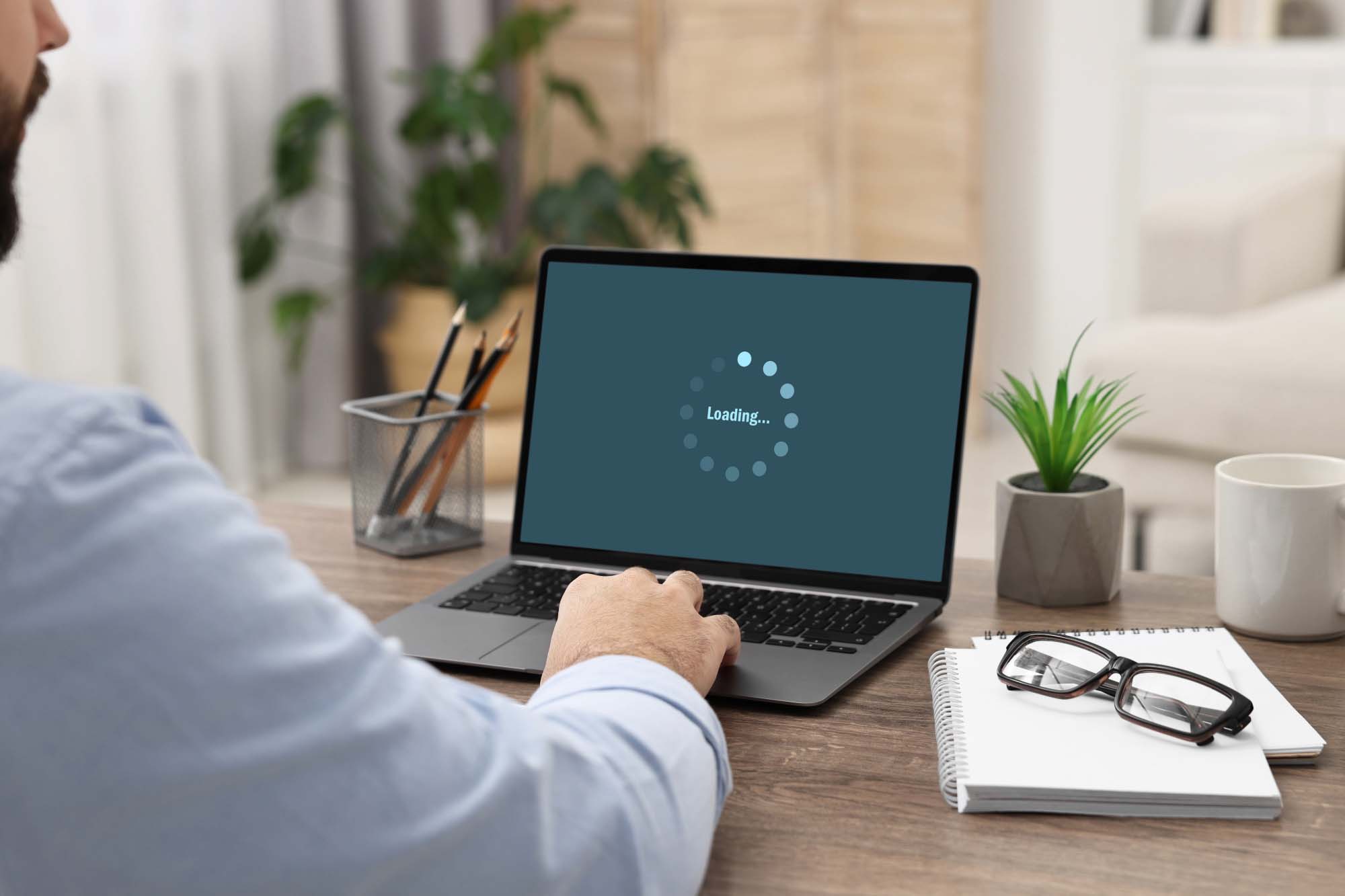 Person waiting for website to load on laptop