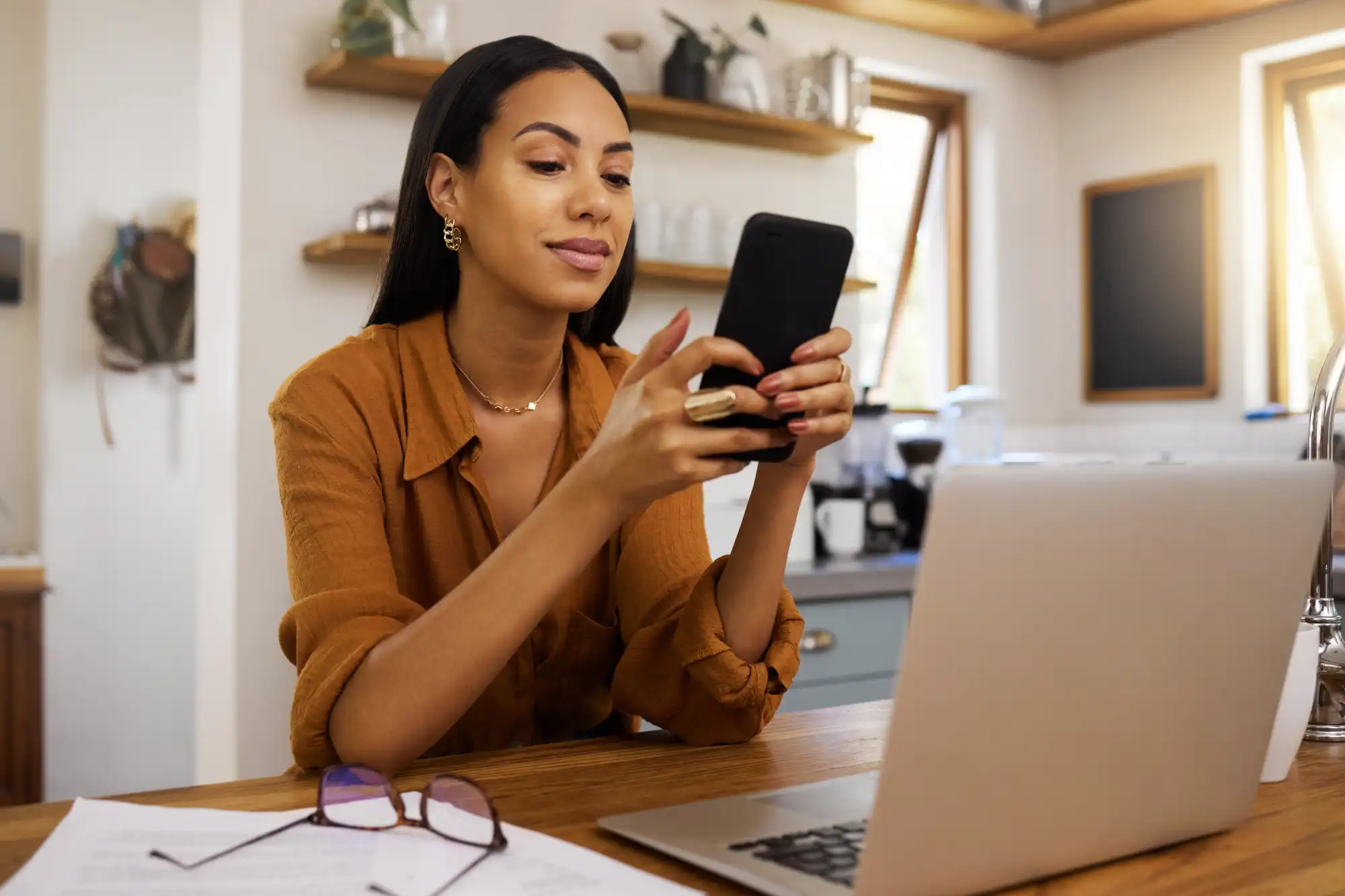 Person looking at laptop and phone